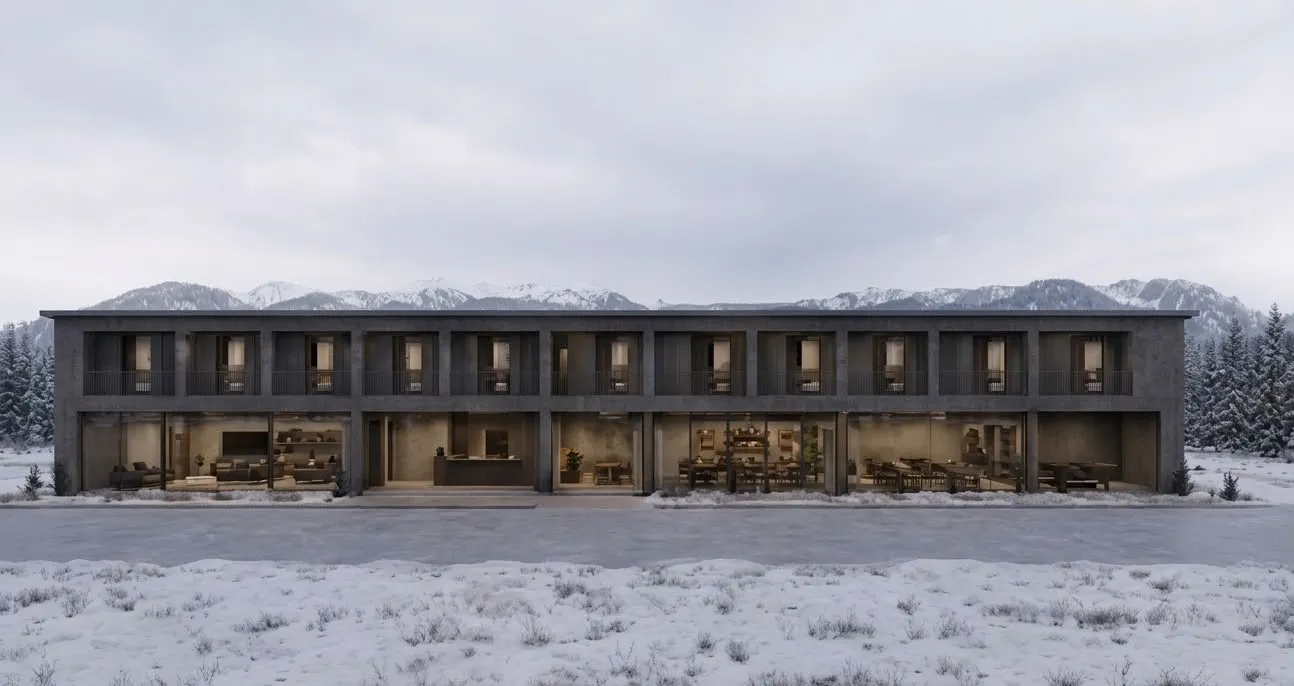 Exterior view of the two-storey accommodation block, with communal areas on the ground floor and snowy mountains behind